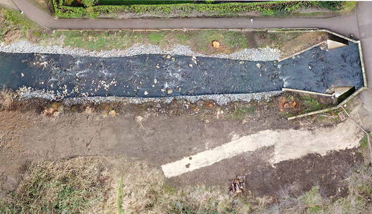 Snakes Lane Weird after restoration work, showing the river channel now strewn with boulders and the weir removed. 